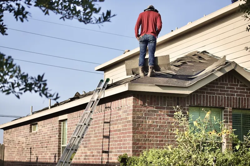 Professional roofer working on a residential roof in Oakley